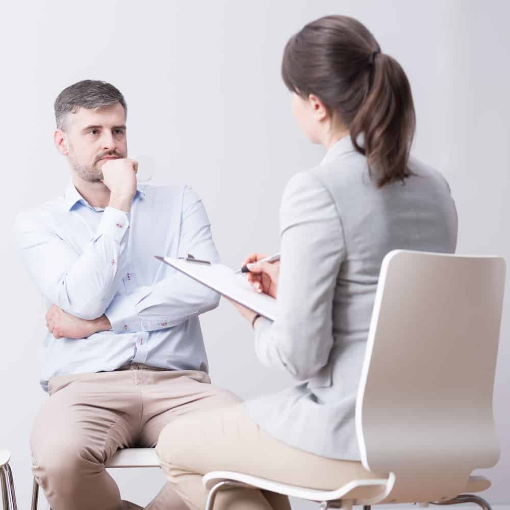 Young,Man,And,Woman,Sitting,On,A,Group,Psychotherapy